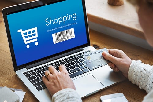 Man with laptop doing online shoppingShopping
