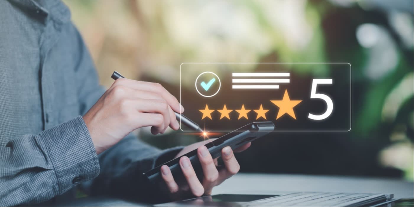 A hand holding a smartphone and using a stylus to give a 5-star rating, with a glowing digital overlay symbolizing positive customer feedback.