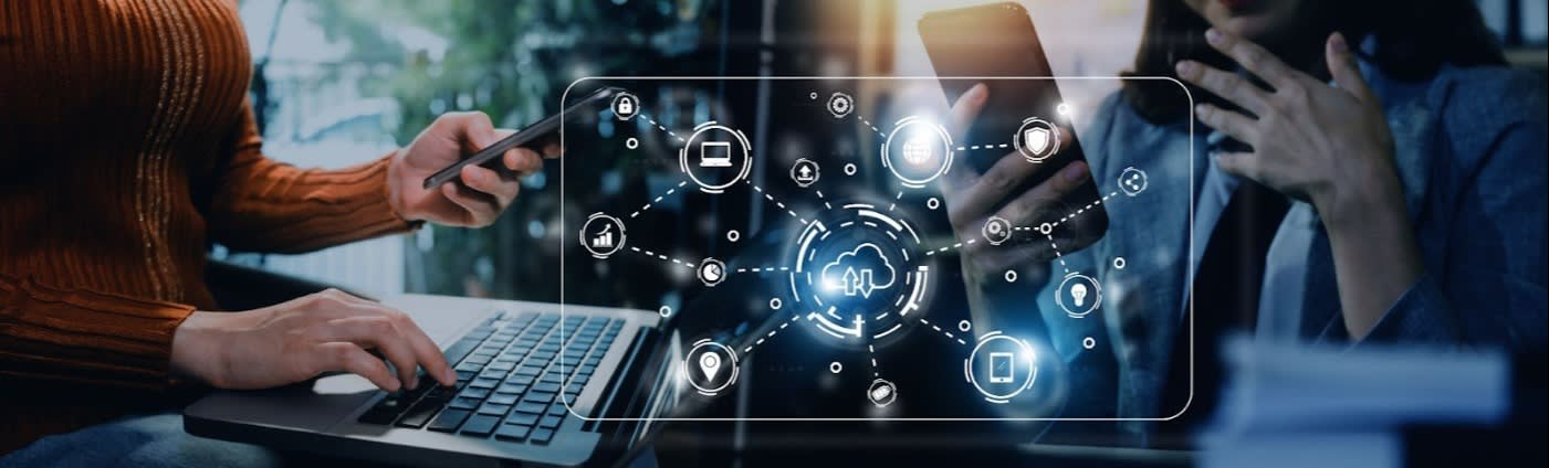 Two people using a laptop and smartphone with cloud computing network icons, symbolizing data synchronization and cloud technology integration.