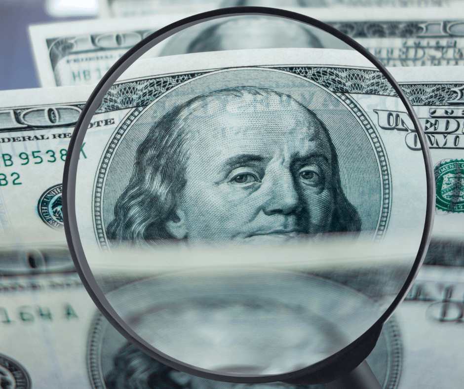 Magnifying Glass Over a 100 Dollar Bill Concept for Making Money on Autopilot