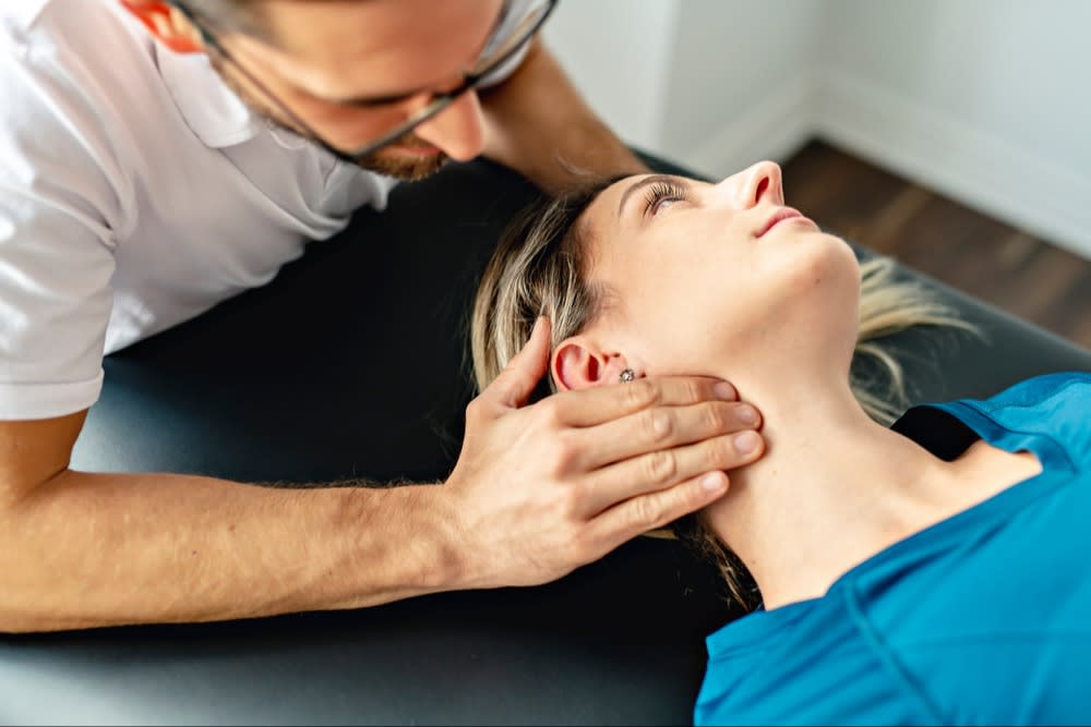 Chiropractor Adjusting Woman's Neck