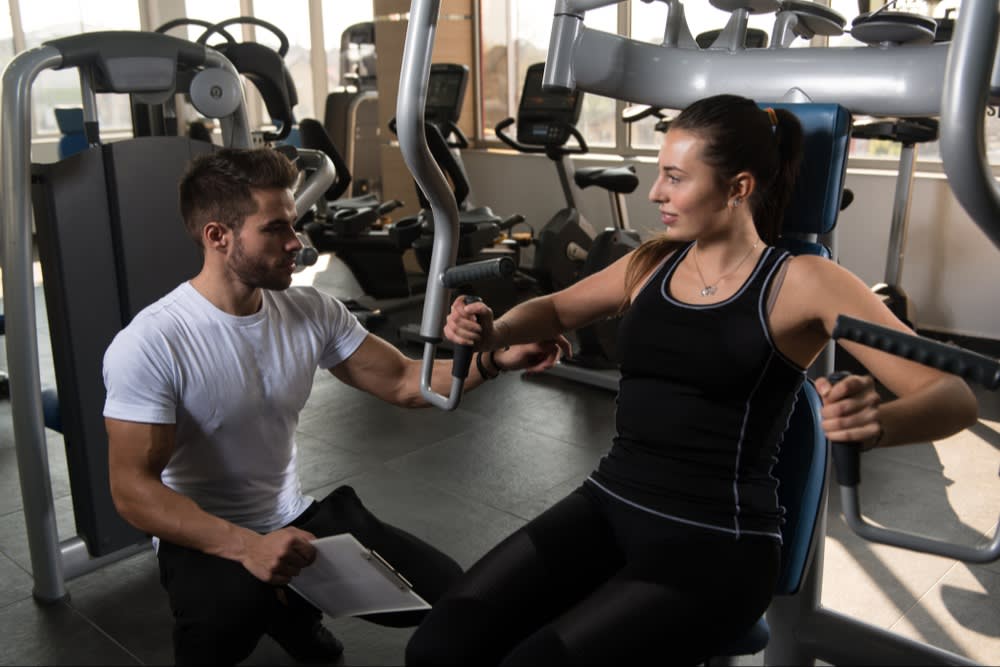 Personal Trainer with Woman in Gym