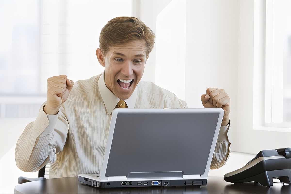Man Excited Looking At Laptop Because of ESTAGE Features