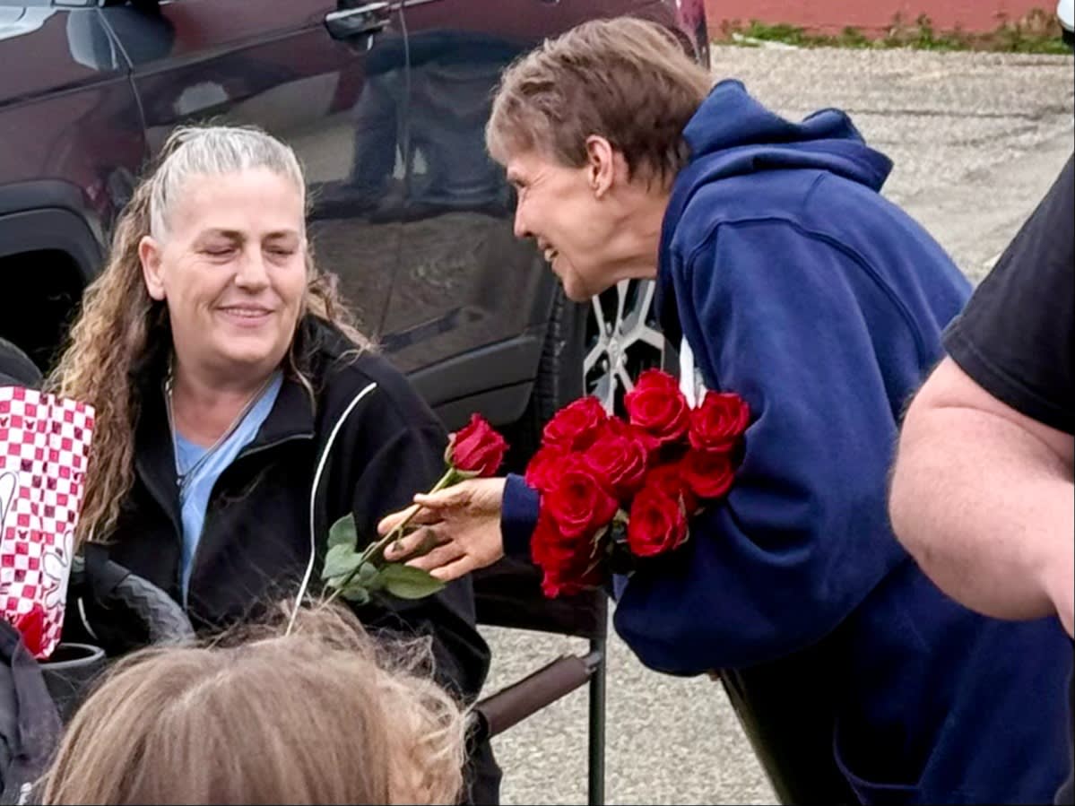 Families and volunteers marching with Mary, distributing roses and sharing smiles along the parade route.