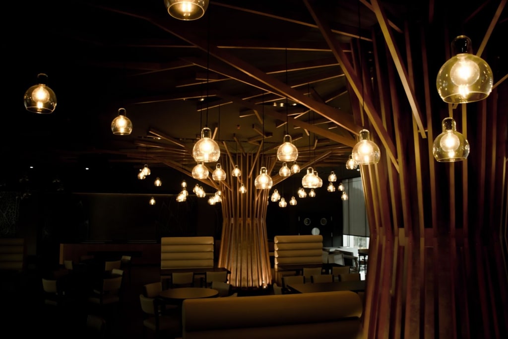 Yellow light bulbs in a dark lounge at Hotel CEIBA. Av. Francisco Mendes