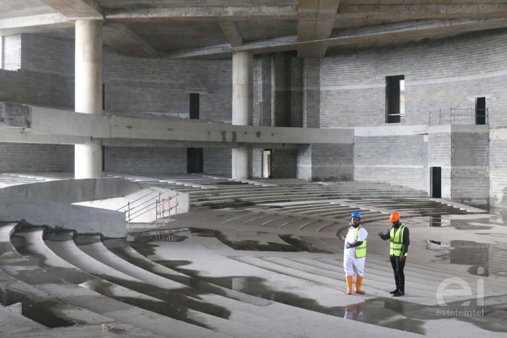 Two estate intel team members standing inside the Trinity Towers church auditorium