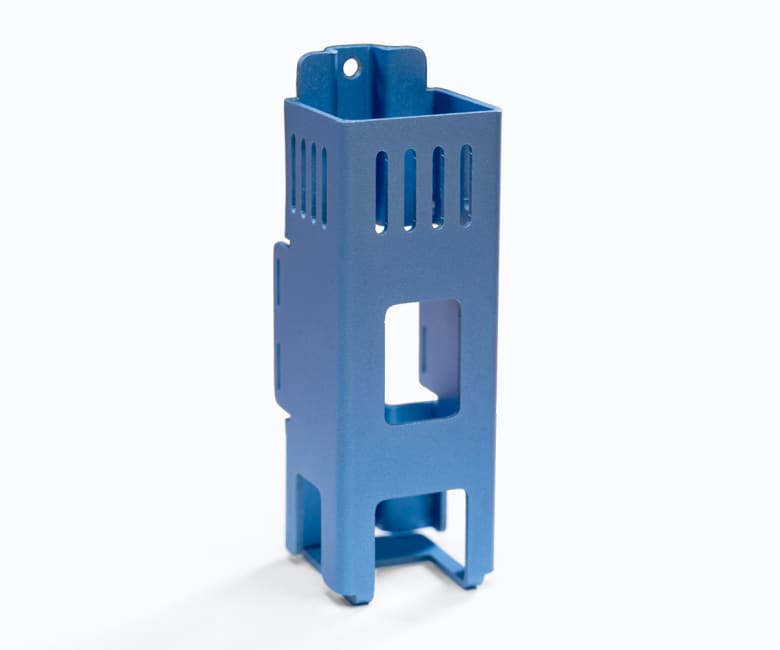 Blue anodized aluminum mounting bracket with ventilation slots, rectangular cutout, and stabilizing feet legs