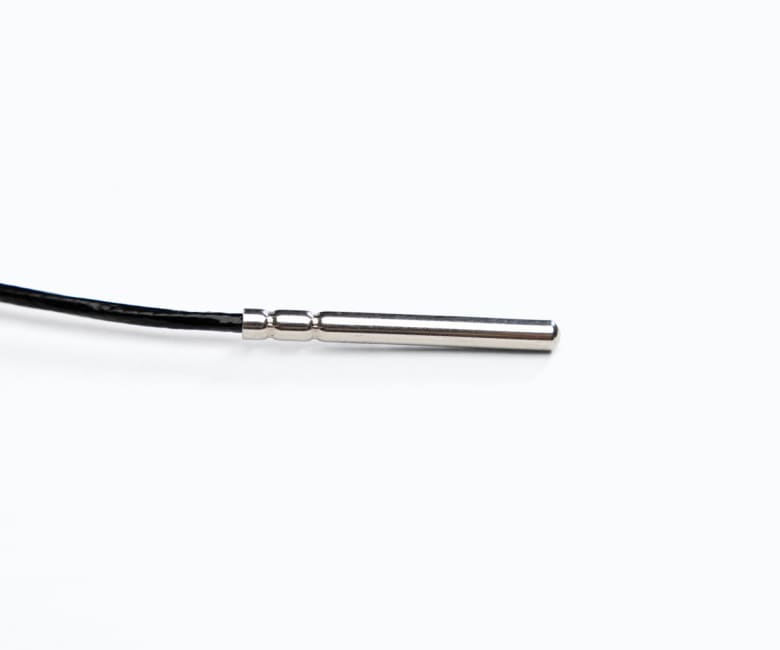 Stainless steel temperature probe sensor with black cable connection on white background