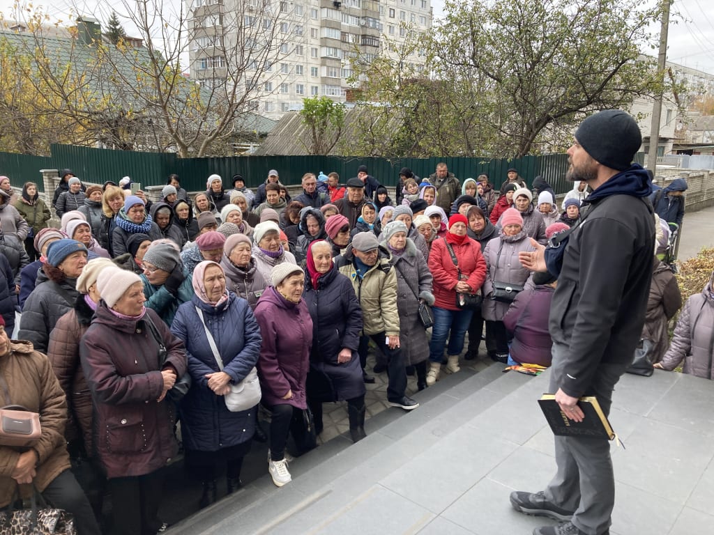 Joshua Steele preaches to a crowd pressed in close around him.