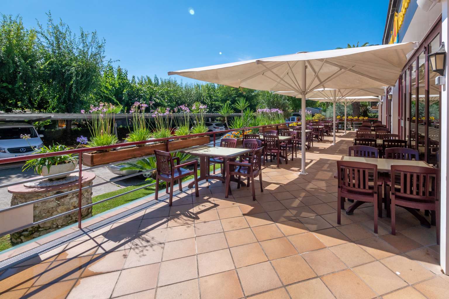 Restaurant terrace tables and chairs under canopy, la Masia campsite, Blanes, Costa Brava