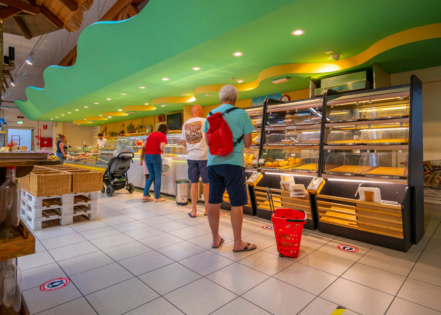People shopping in the bakery section of supermarket at Portofelice camping village, near Venice
