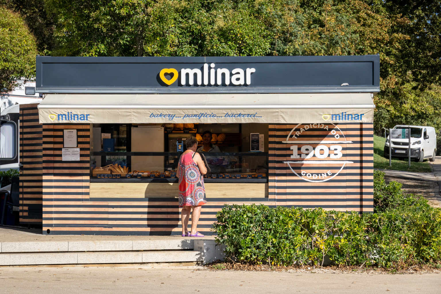 Customer shopping at the onsite bakery at Bijela Uvala campsite, Porec, Croatia