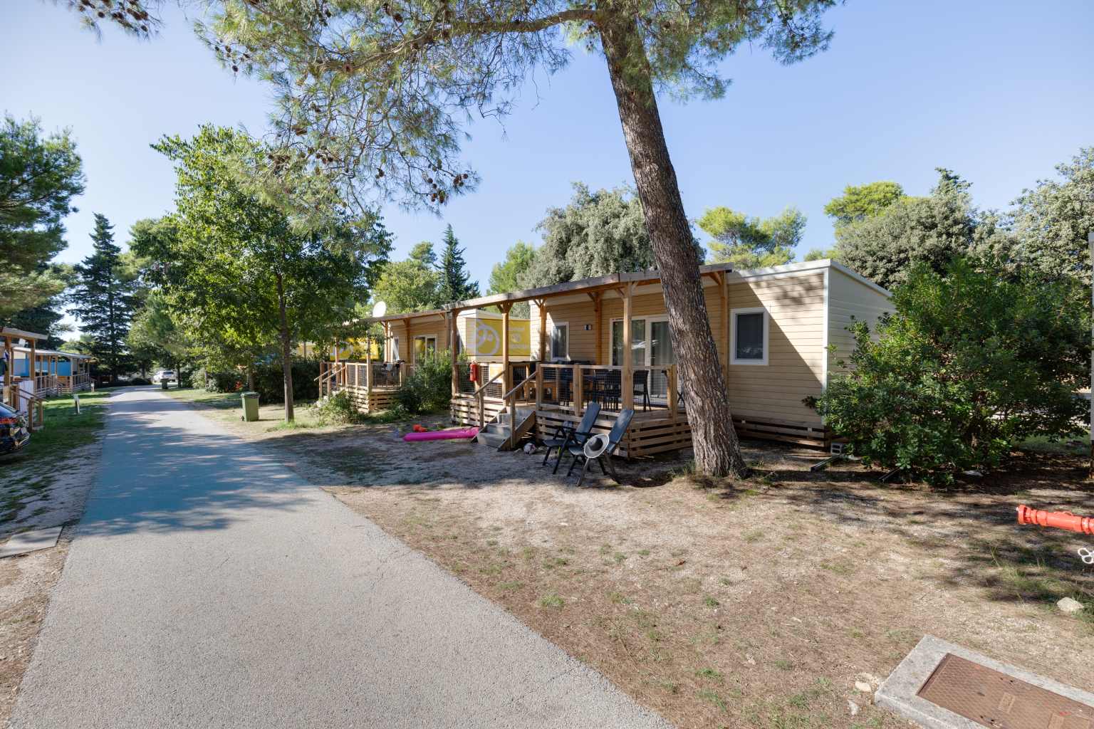 Holiday homes with partially covered decks facing each other across a road at Zaton Holiday Resort, in Dalmatia, Croatia