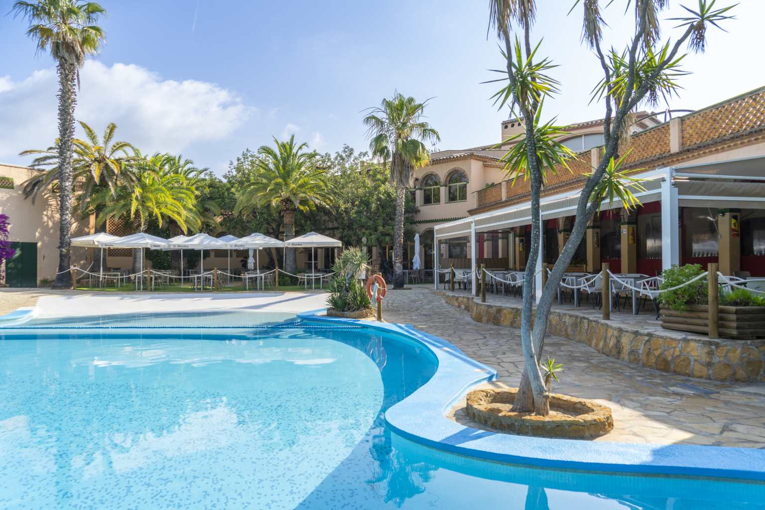 Poolside bar and restaurant restaurant terrace tables at La Torre del Sol campsite, Costa Dorada