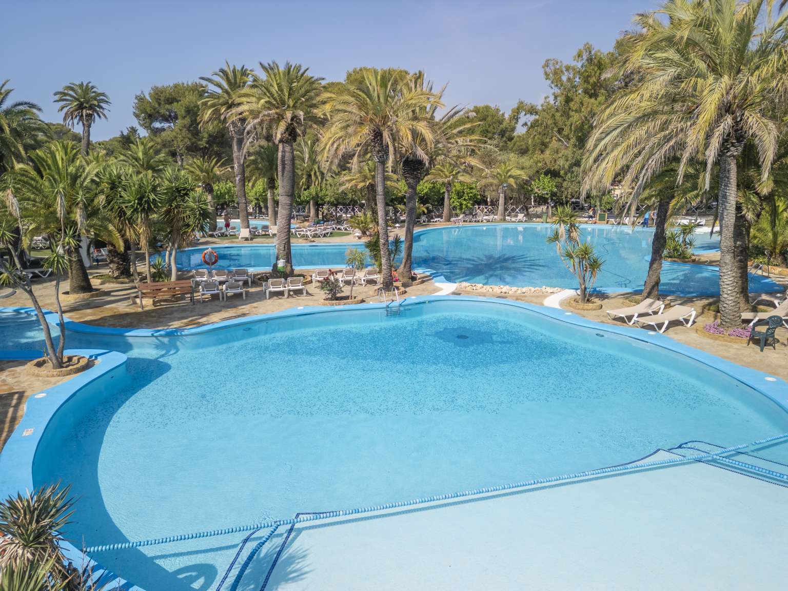 Palm fringled lagoon pools at at La Torre del Sol campsite, Miami Platja, Costa Dorada