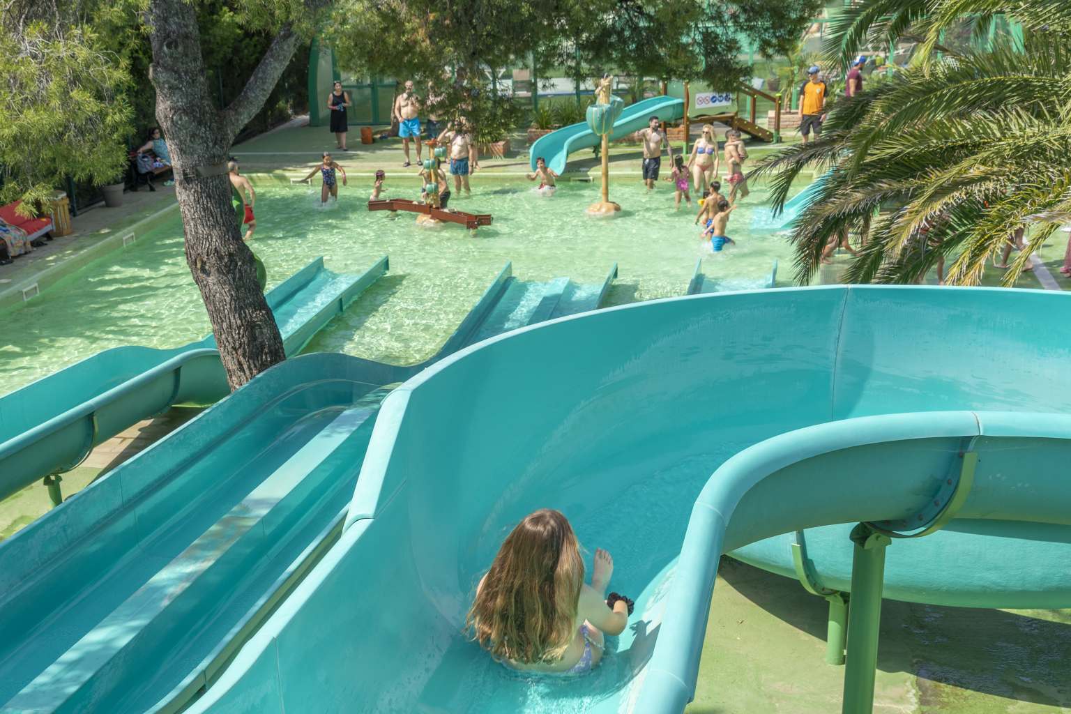 Child on the curved waterslide at La Torre del Sol campsite, Miami Platja, Costa Dorada