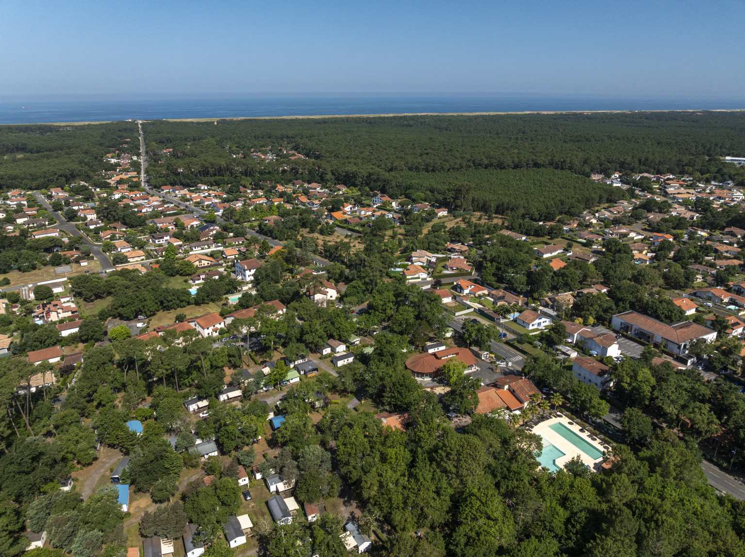 Aerial view showing the straight road past Lou Pignada campsite to Ondres beach, Landes