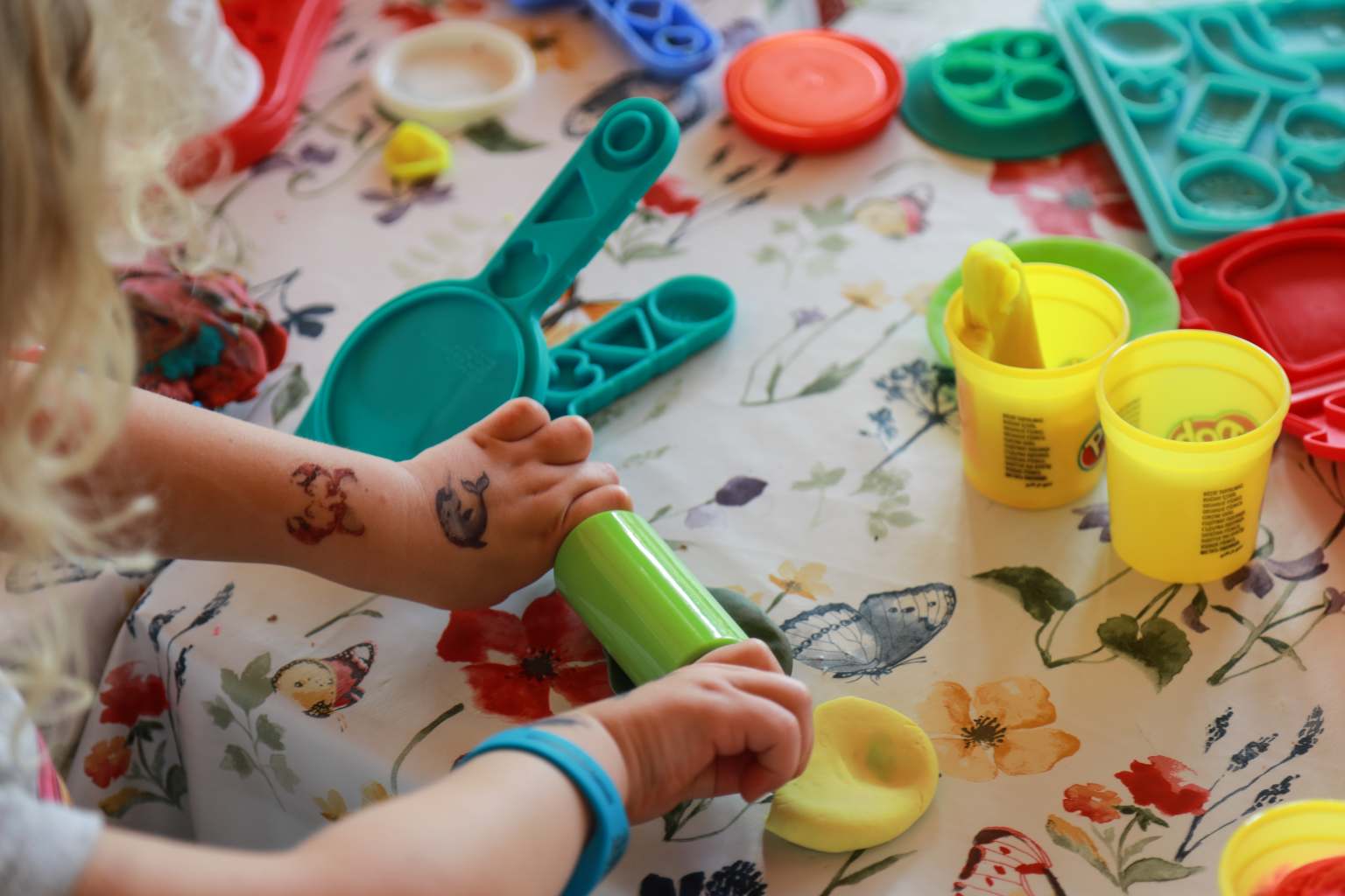 Little hands rolling out Play Doh, various cutters and shapes, Kids Club play at Spreewaldtor campsite, Berlin Brandenburg, Germany