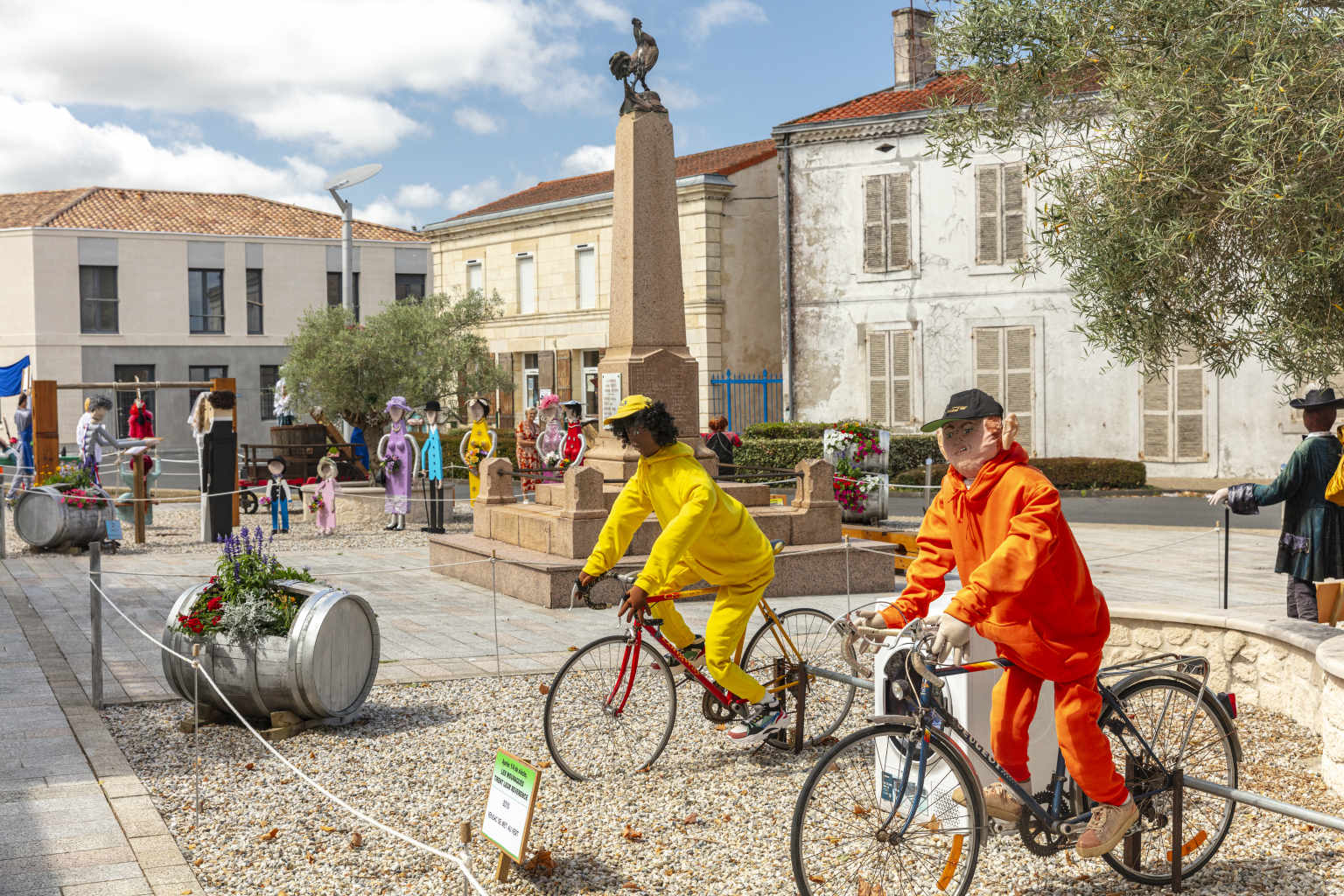Local town festival with dressed characters mounted on bikes near Le Vieux Moulin campsite, Gironde
