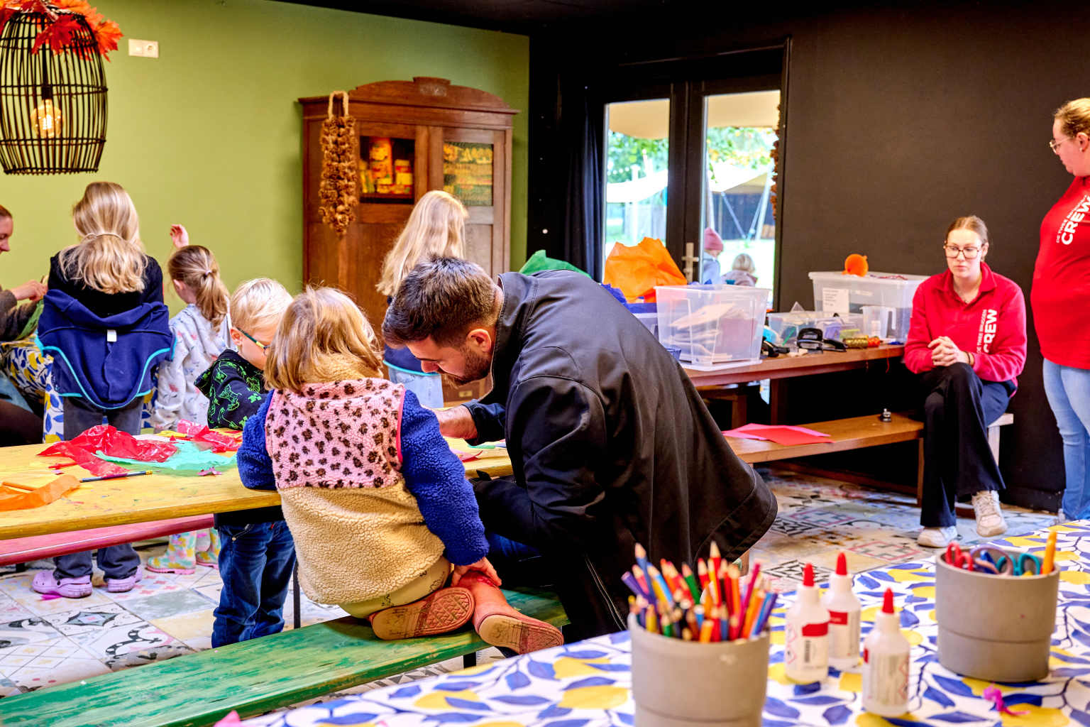 Kids taking part in craft activities in the indoor room in the kids club at Camping De Twee Bruggen in the Netherlands