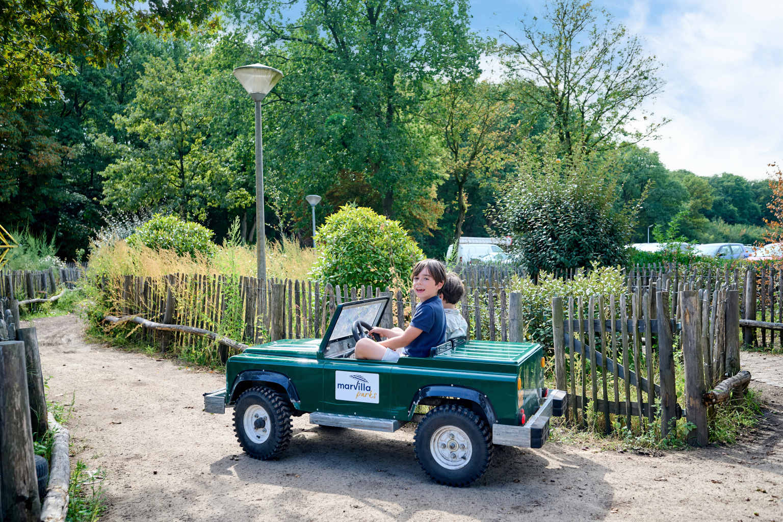 Boy riding mini car round the parc at Marvilla Parks Kaastsheuvel, North Brabant, Netherlands