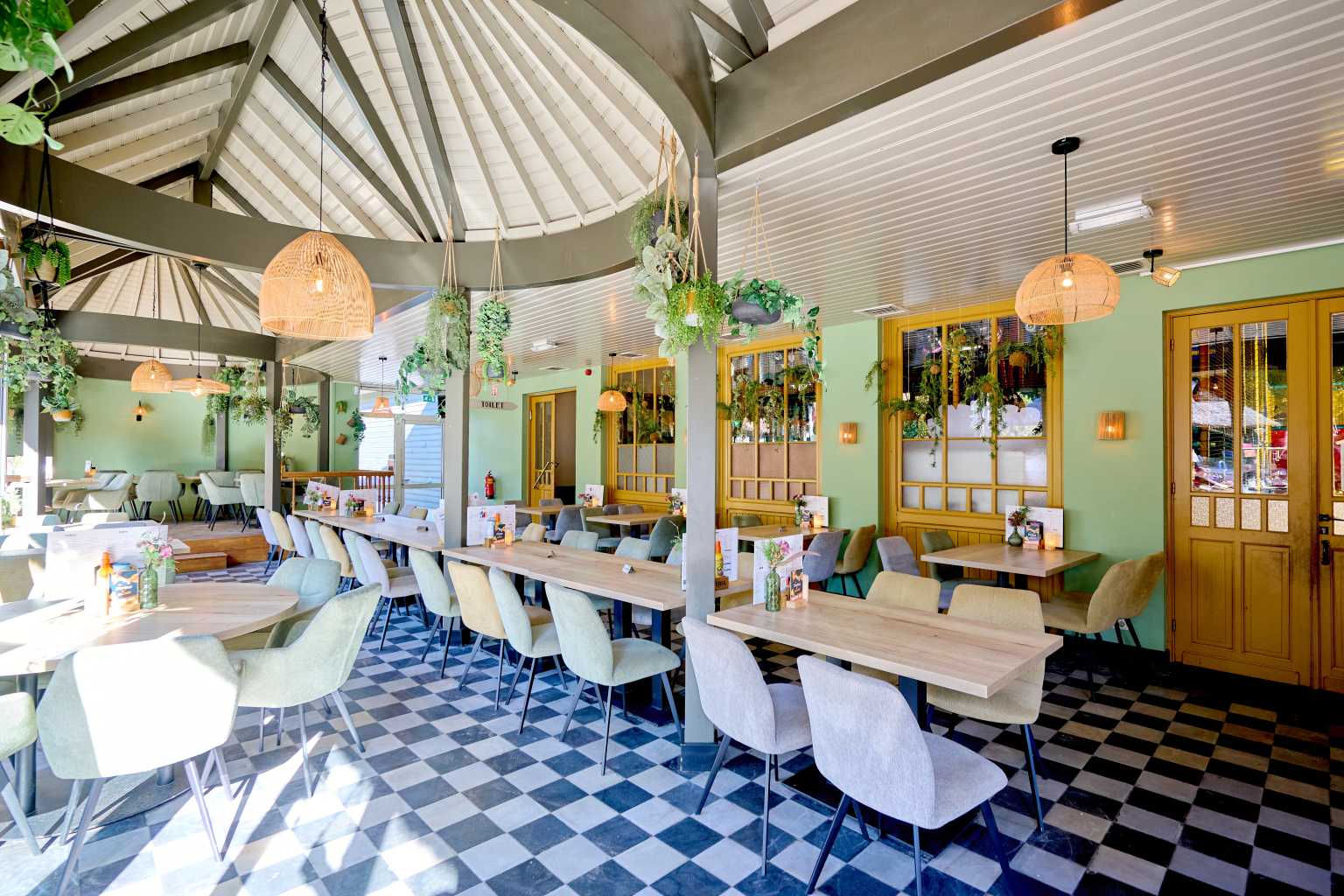 Interior view of restaurant, tables, chairs, lofted beamed ceiling at Marvilla Parks Kaastsheuvel, North Brabant, Netherlands