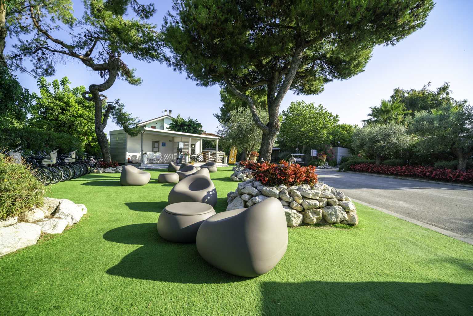 Park entrance tables and chairs on the lawn at Stork campsite, Abruzzo, Italy