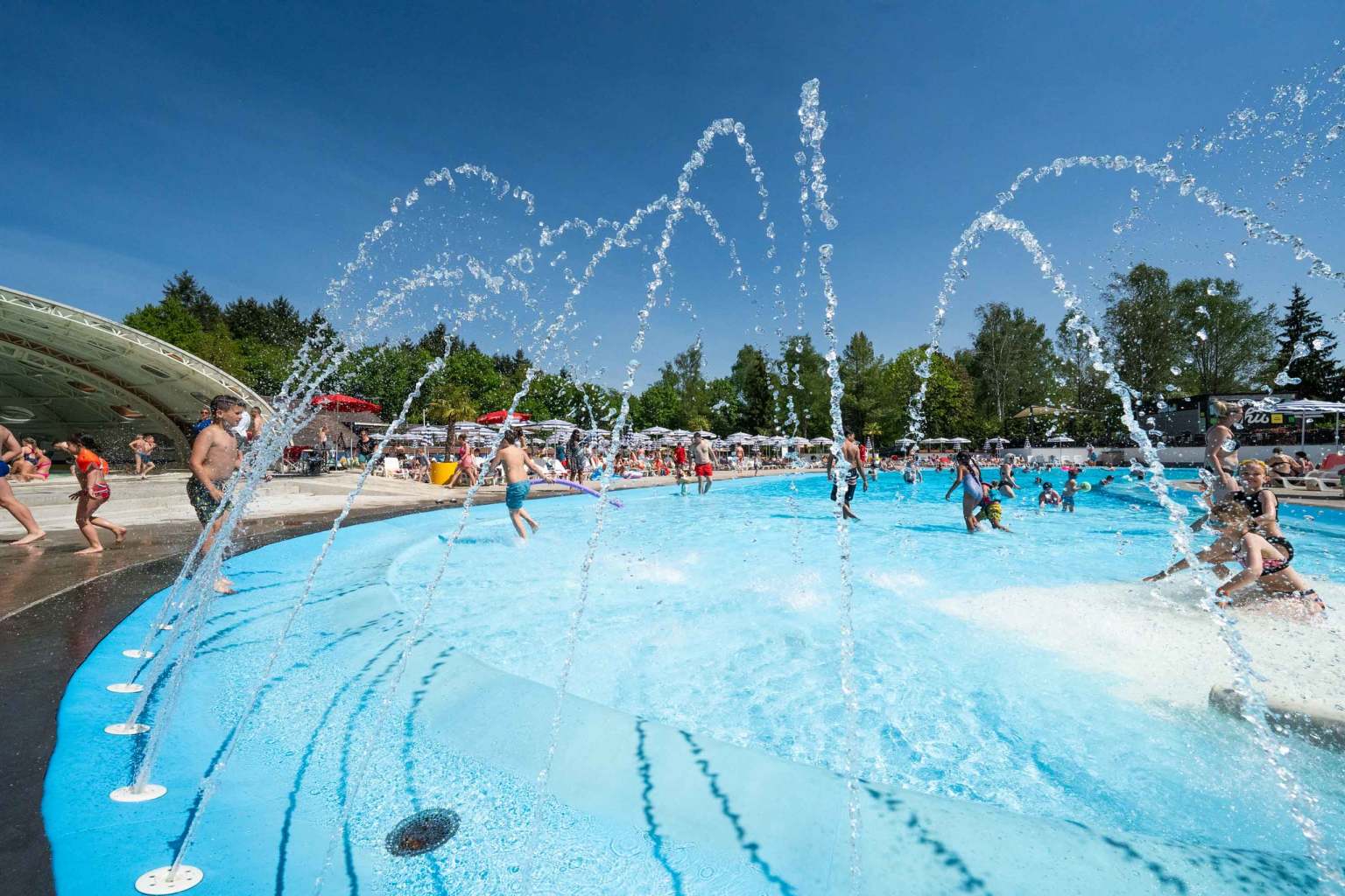 Fountains splashing into the outdoor pool at Hu Birkelt Village campsite in Luxembourg