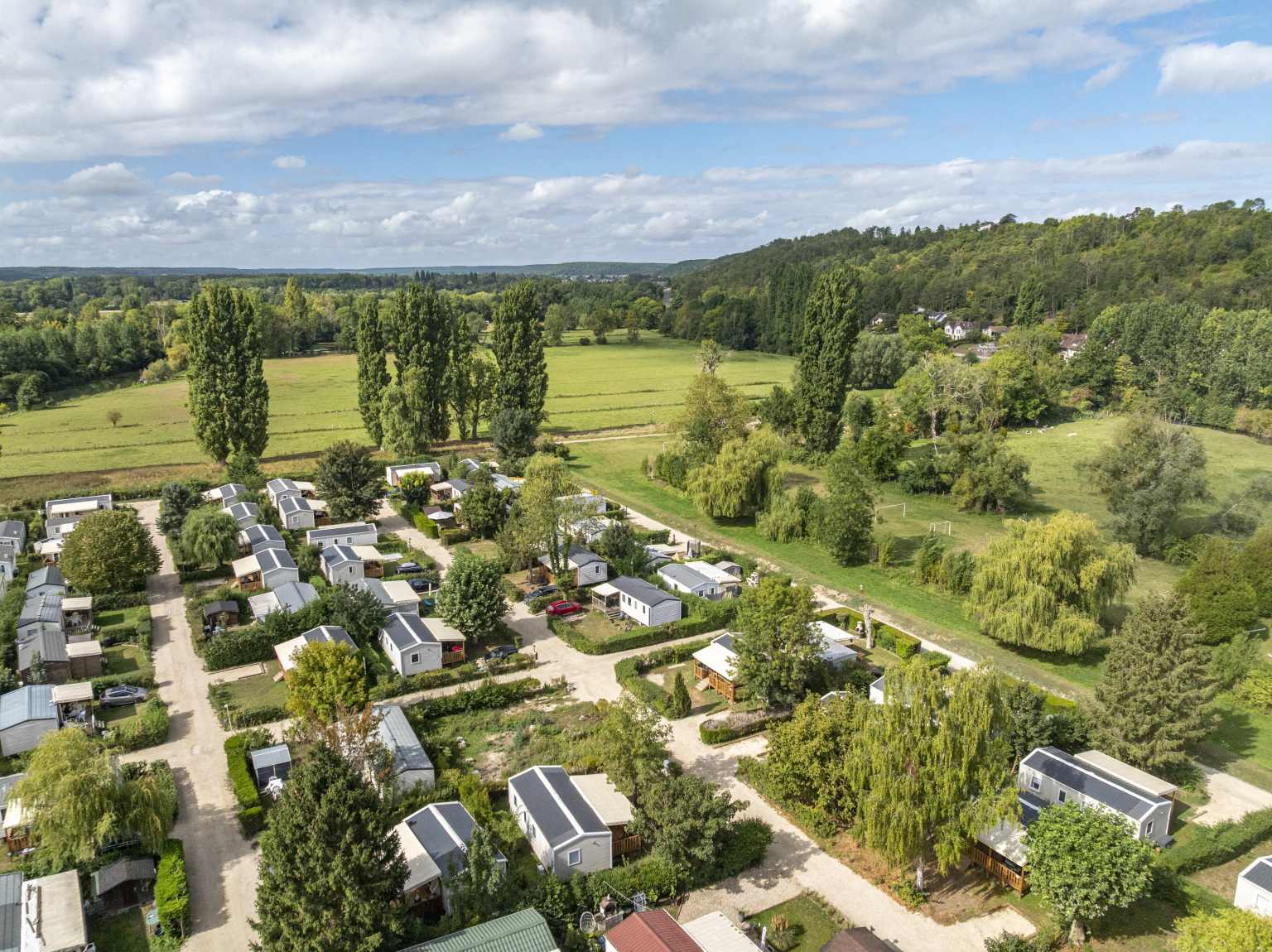 Aerial view of the holiday homes and fields around the parc at Les Fontaines campsite, Ivry-la-Bataille, France