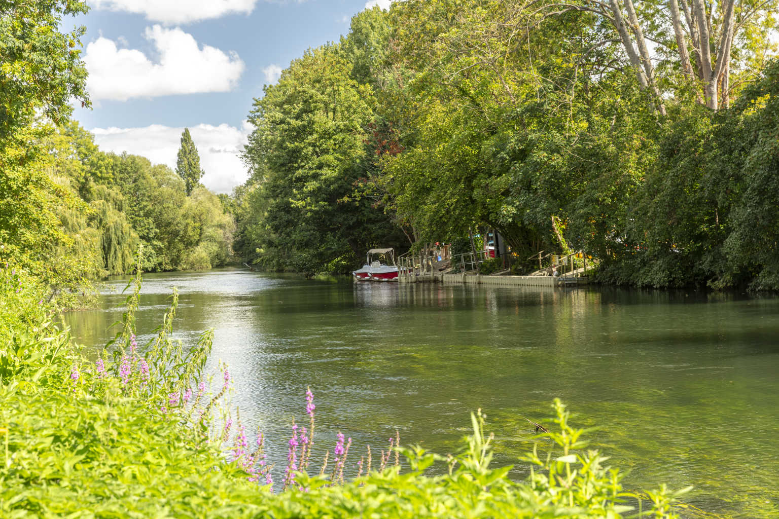 Tree lined river, with jetty on the far shore, at Les Fontaines campsite, Ivry-la-Bataille, France