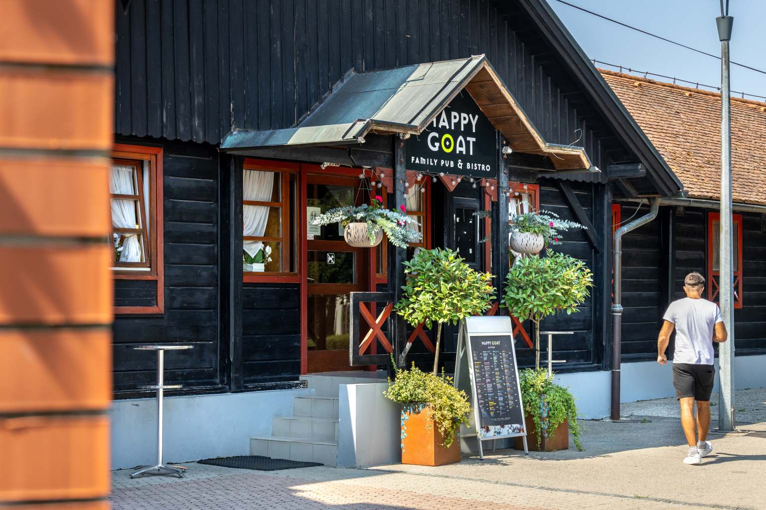 Adult walking into the Happy Goat fast food restaurant at Terme Čatež campsite in Slovenia