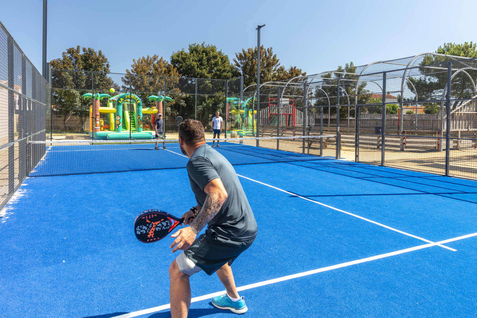 Man playing padel tennis at L'Oceano d'Or campsite in the Vendée