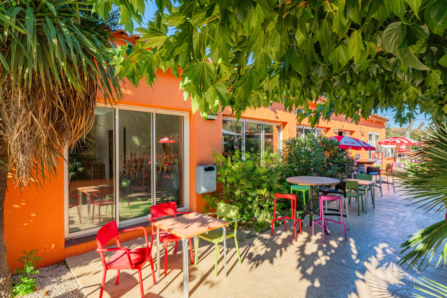 Tables and chairs sat by the bar restaurant at Ma Prairie campsite in Roussillon, France
