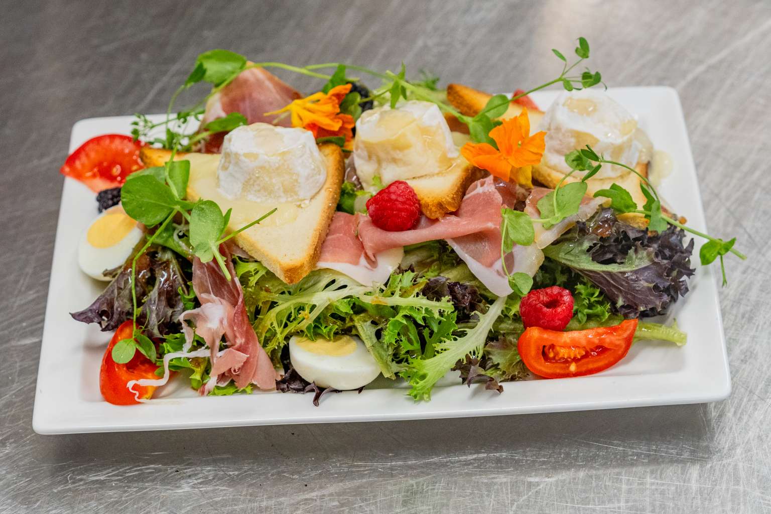 Plate of cold meat, cheeses and salad available at Domaine de Massereau campsite, Languedoc