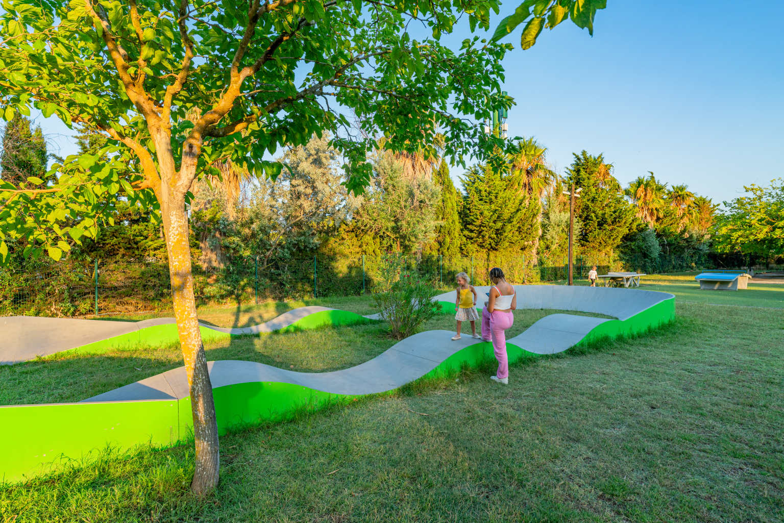 Oval Acro games track course, for bikes and skateboards on the lawn, near trees at la Palmeraie campsite, Roussillon