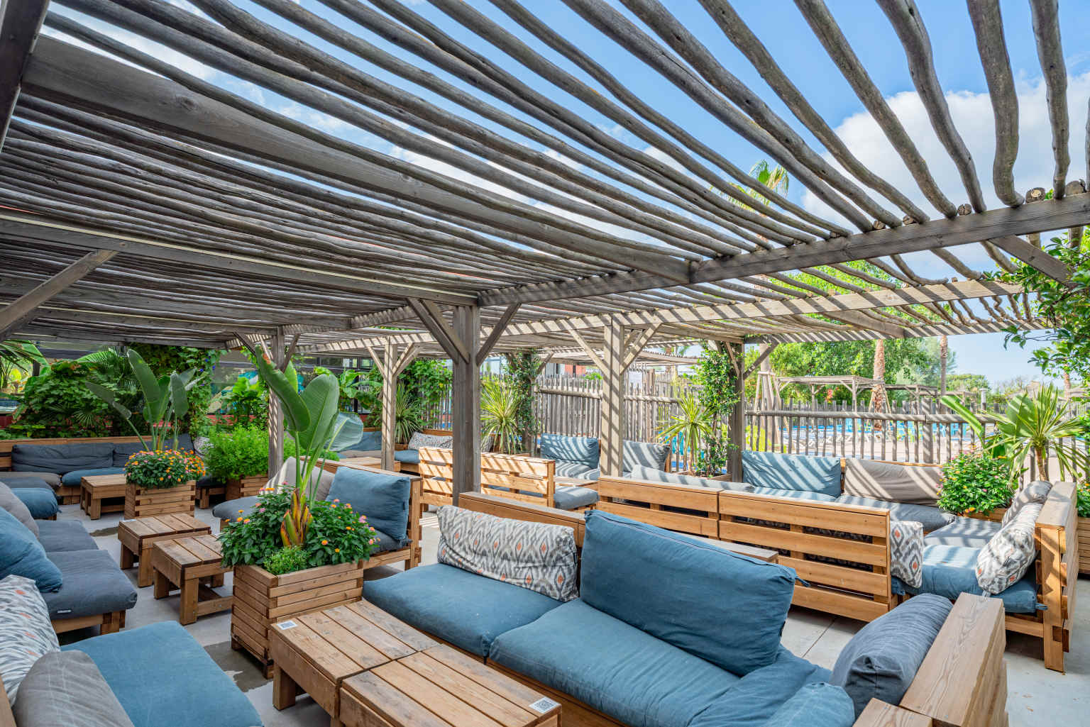 Shaded outdoor seating area with comfy sofas at le Beach Barden campsite in the Languedoc