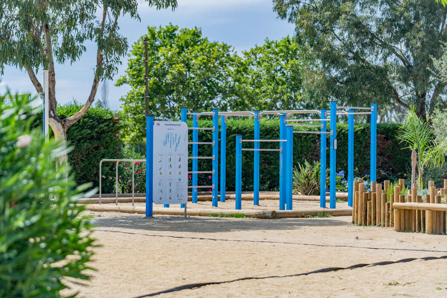 Work out park with metal bars at various heights, sandy surface under trees, at le Soleil de la Mediterranee campsite, Roussillon