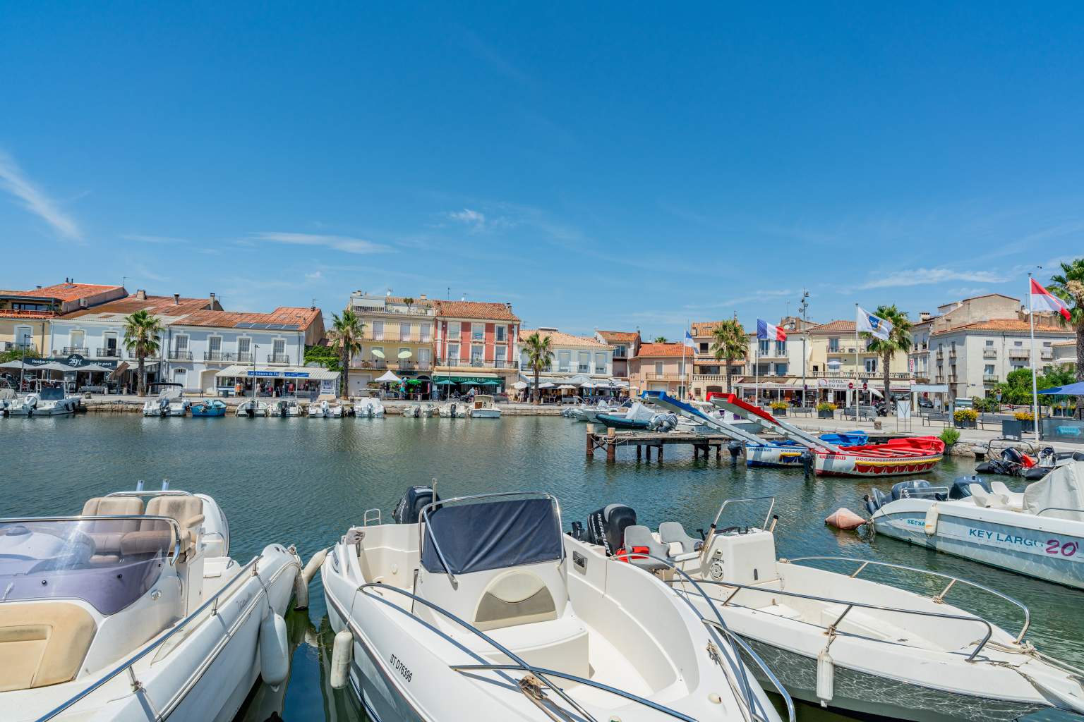 Motor boats facing the rows of flats and houses on the opposite shore of the canal in Sete in the Languedoc