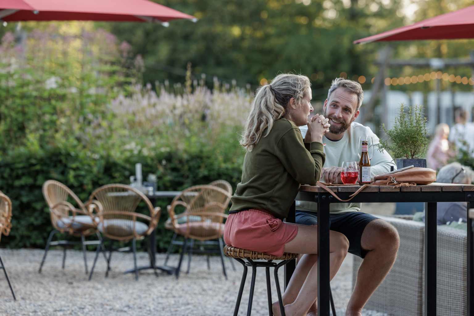 Couple sat outside on the restaurant terrace at Camping de Twee Bruggen in the Netherlands