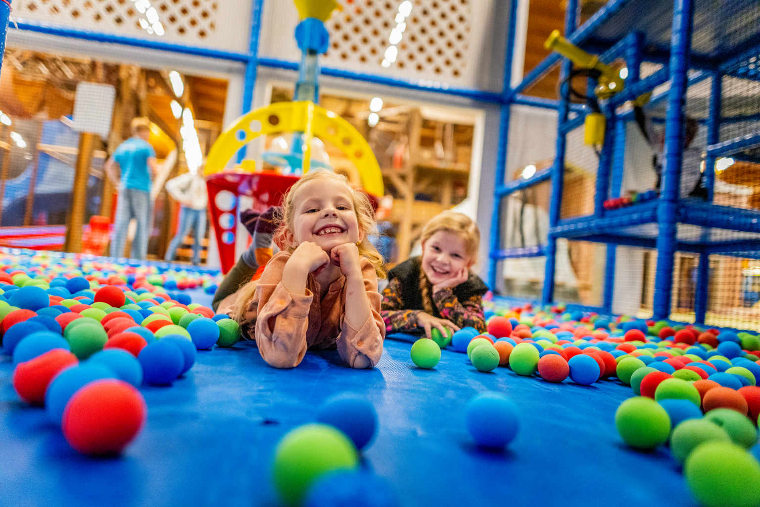 KIds lying down in the indoor ball pit and play gym at Vakantiepark de Bergen campsite in the Netherlands