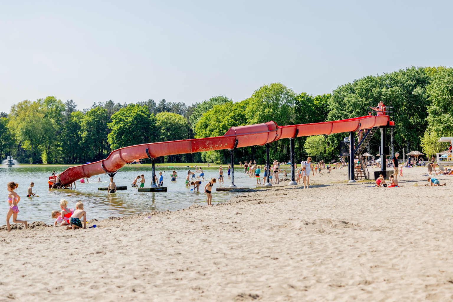 Lake waterchute and sandy lake beach at Vakantiepark de Bergen campsite in the Netherlands
