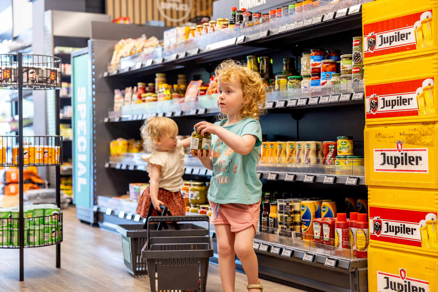 Small children in the on site supermarket at Vakantiepark de Bergen campsite in the Netherlands