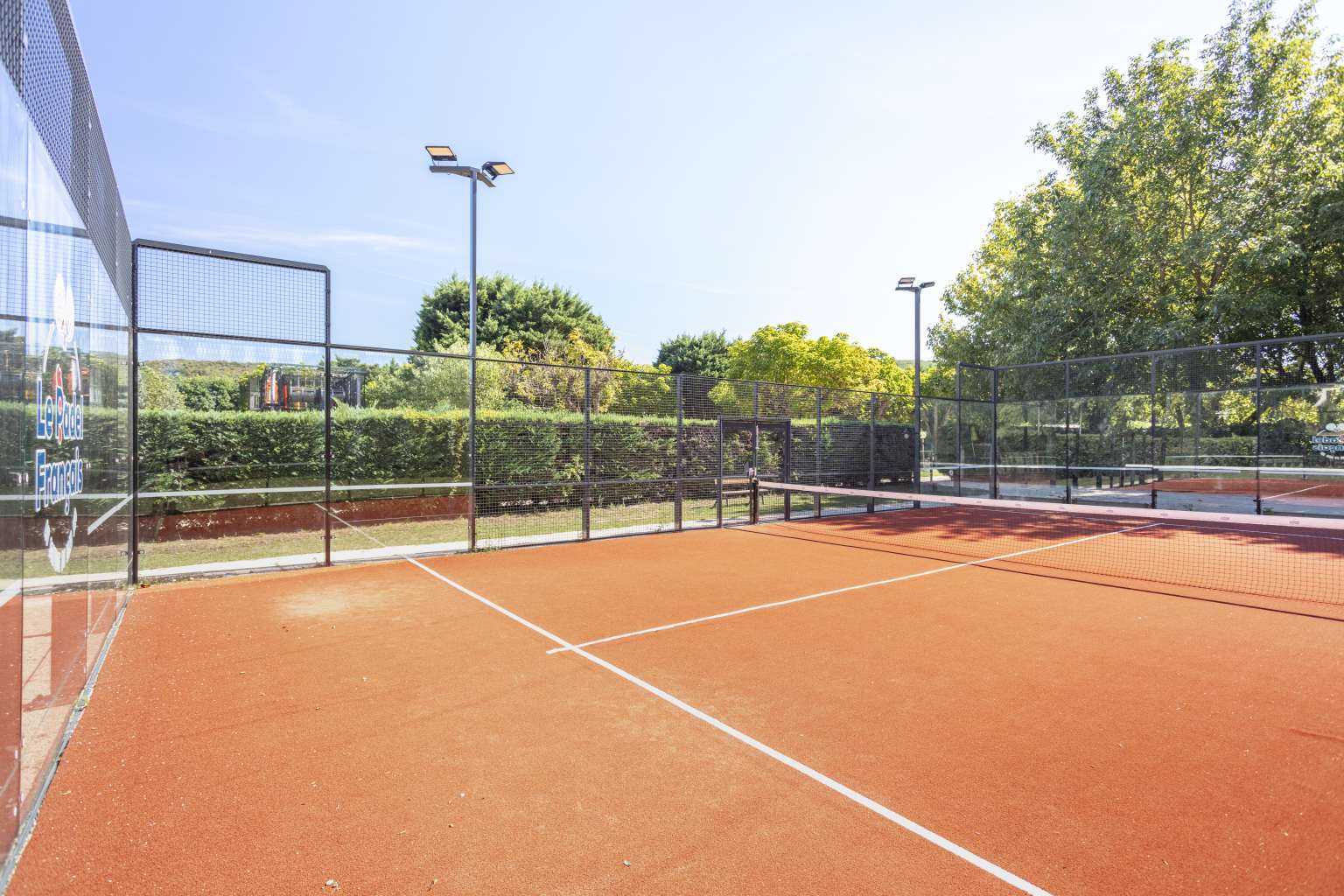 Orange padel tennis court at Camping l’Ardéchois, Vallon-Pont-d'Arc