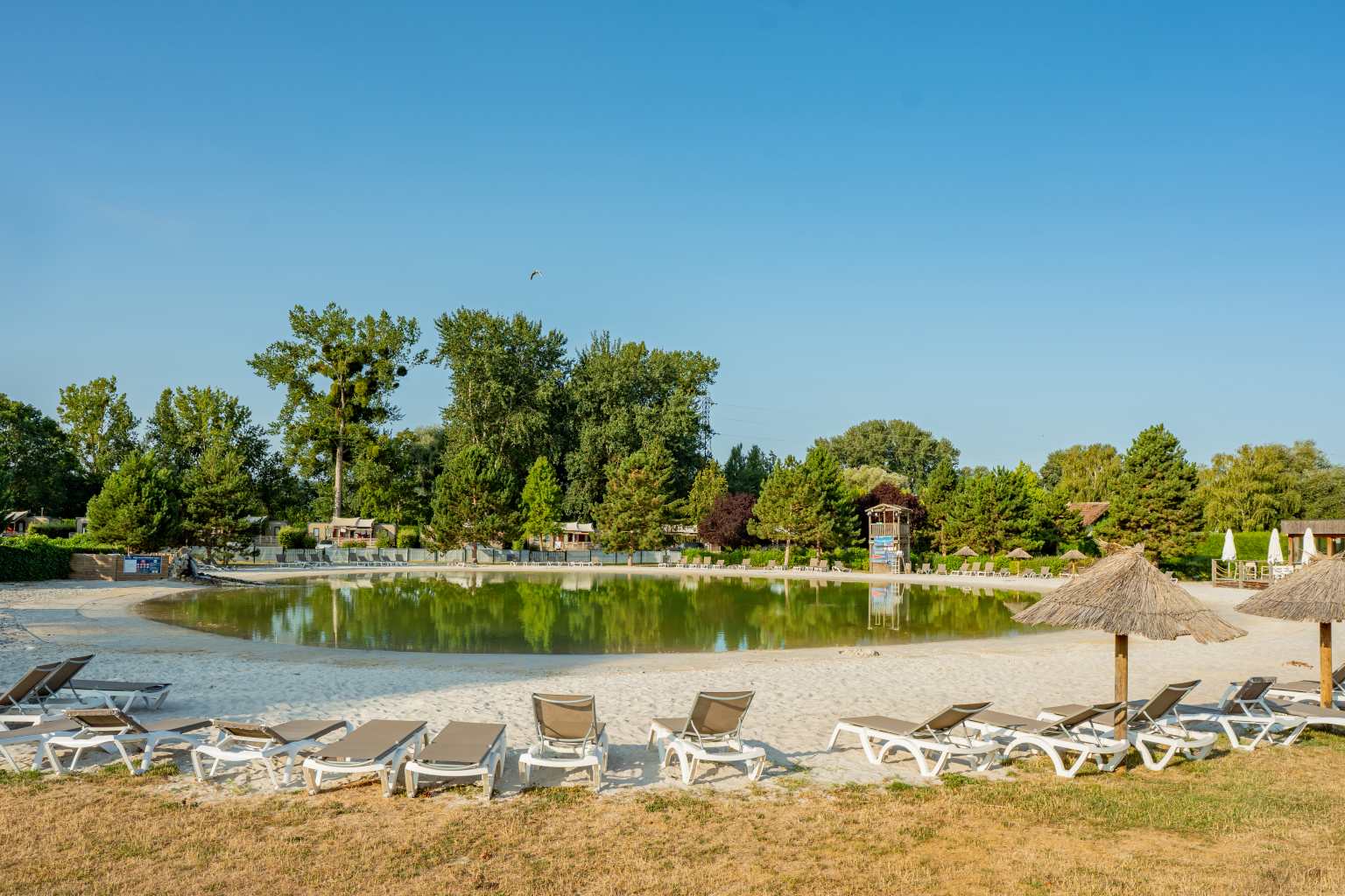 Water bubbling into the lagoon pool from rocky inlet at la Croix du Vieux Pont campsite near Paris