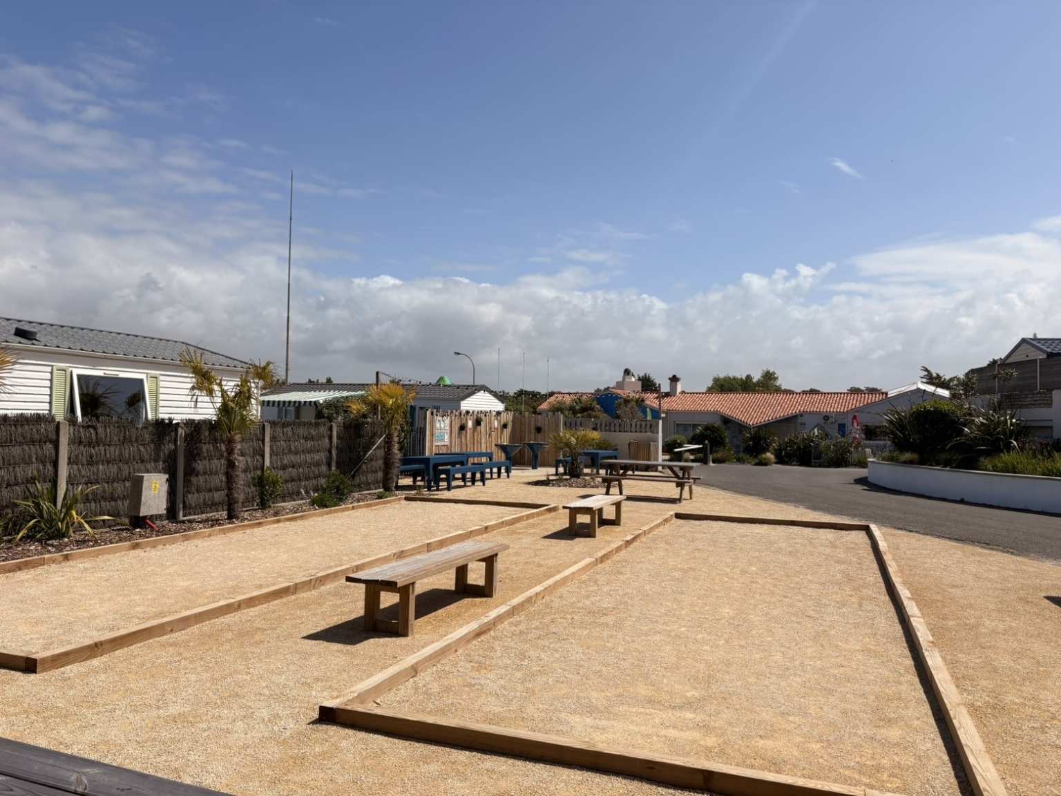 2 boules courts with benches besides them at Sol a Gogo, Vendee