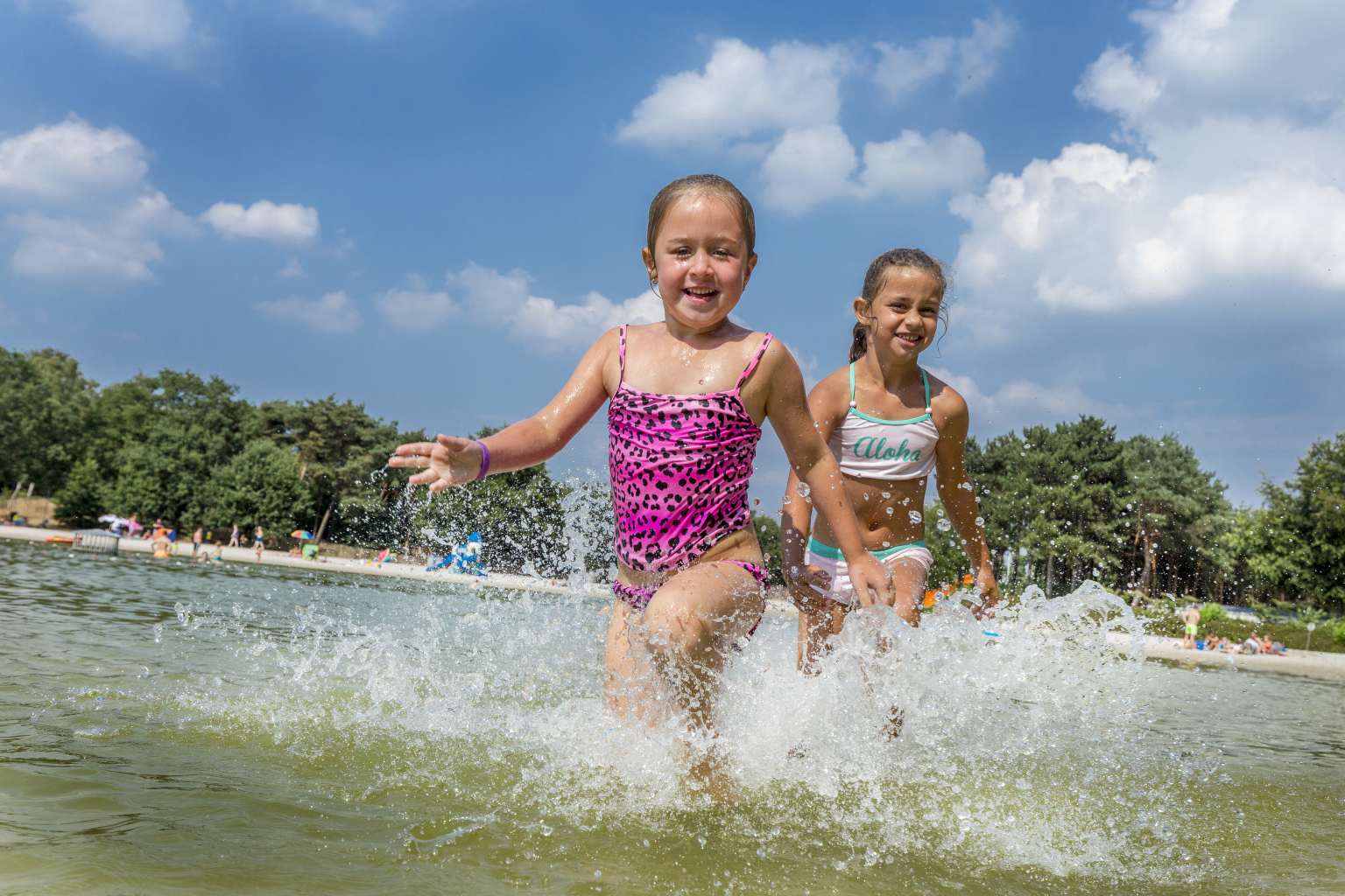 2 girls splashing in the lake at Vakantiepark de Bergen campsite, Netherlands
