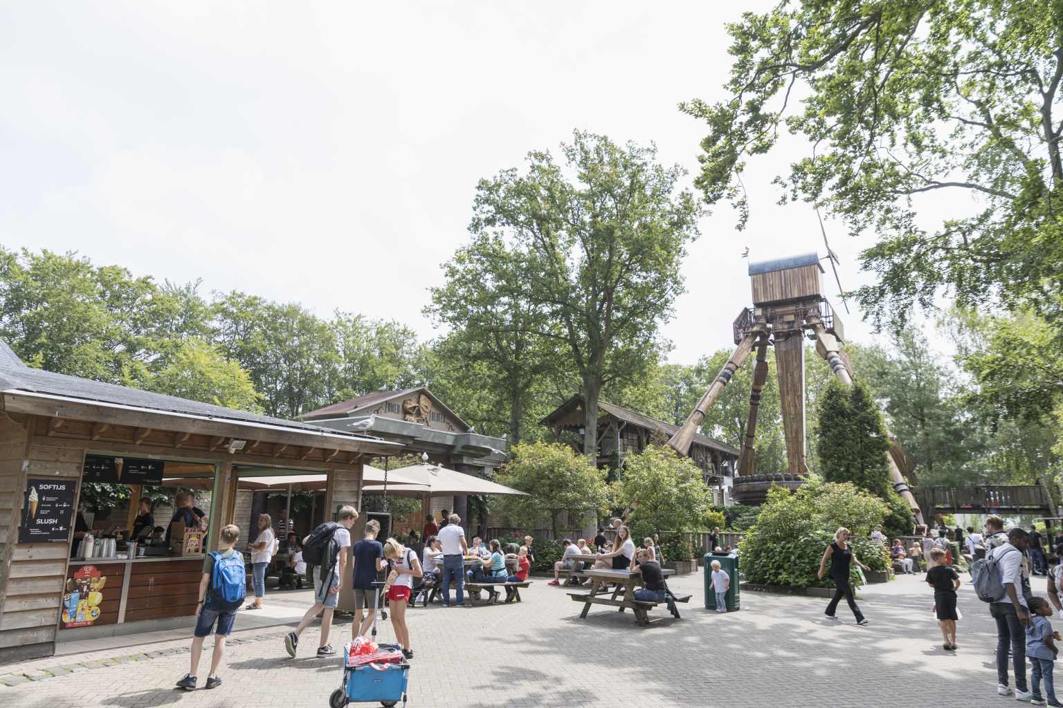 People sat outside on picnic benches at Duinrell theme park in the Netherlands