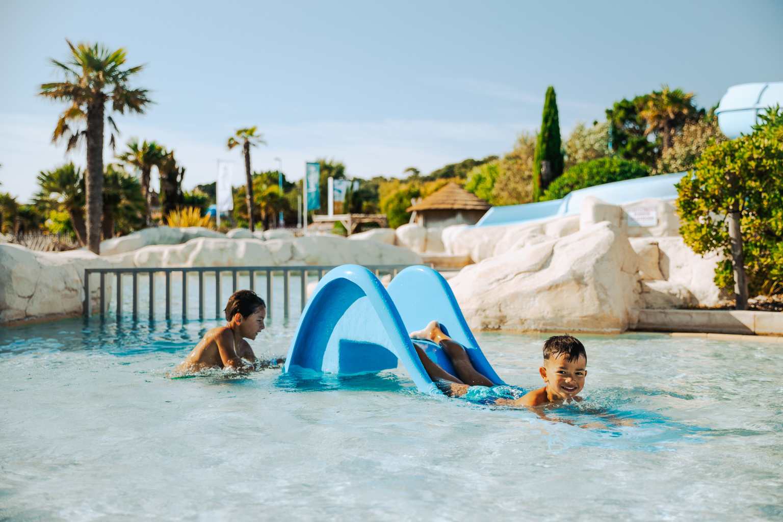 Pool area with toddler waterslides at Camping Les Places Dorées in the Vendée