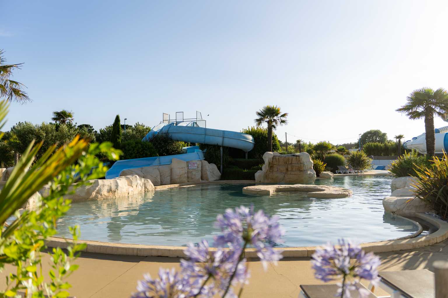 Pool area with waterslides at Camping Les Places Dorées in the Vendée