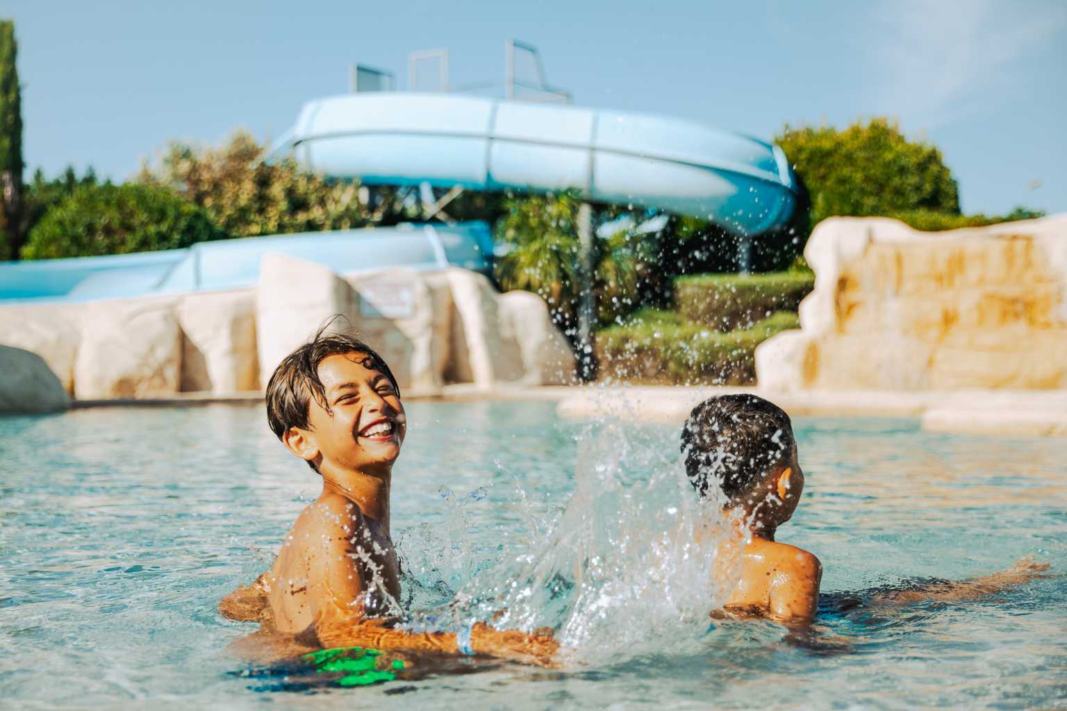 Pool area with waterslides at Camping Les Places Dorées in the Vendée